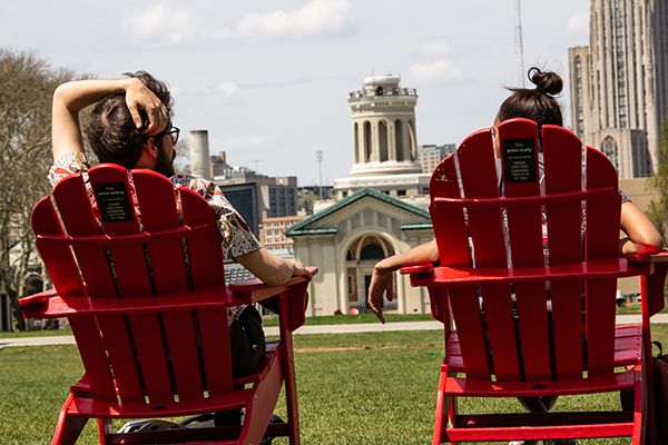 Students relax outside Hamerschlag Hall in chairs donated to the university.
