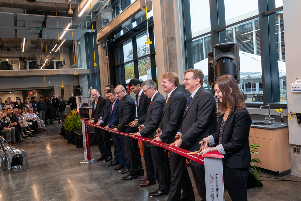 Ribbon cutting ceremony with nine people