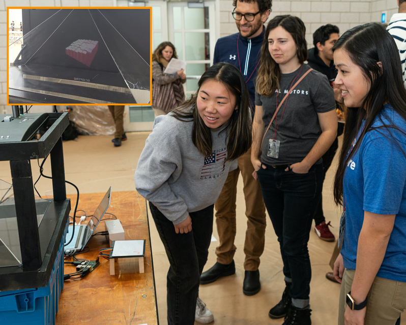 Group of students checking out a screen