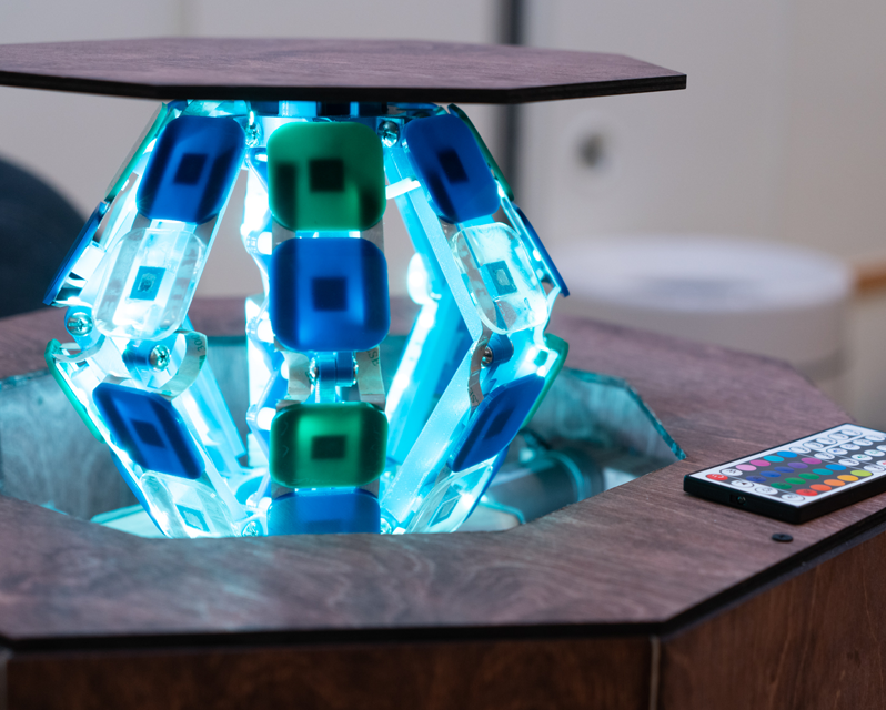 A lit-up claw raising the center of a table