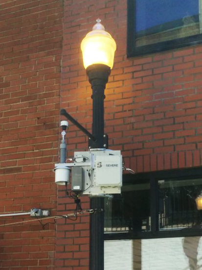 A lightpost with a sensor attached to it