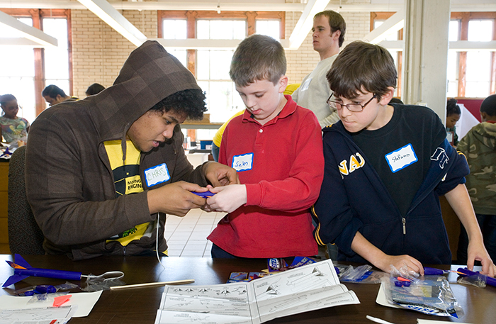 Three elementary school boys working on an engineering project.